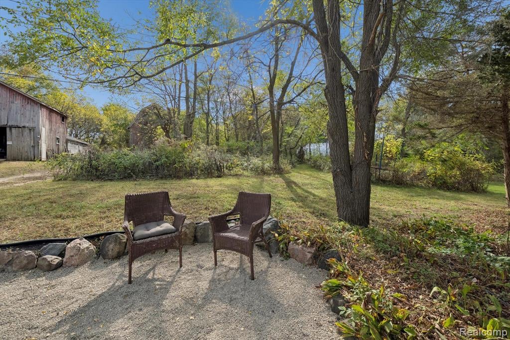 Backyard of the 4-bedroom home for sale at 13278 9 Mile Road, South Lyon, MI,