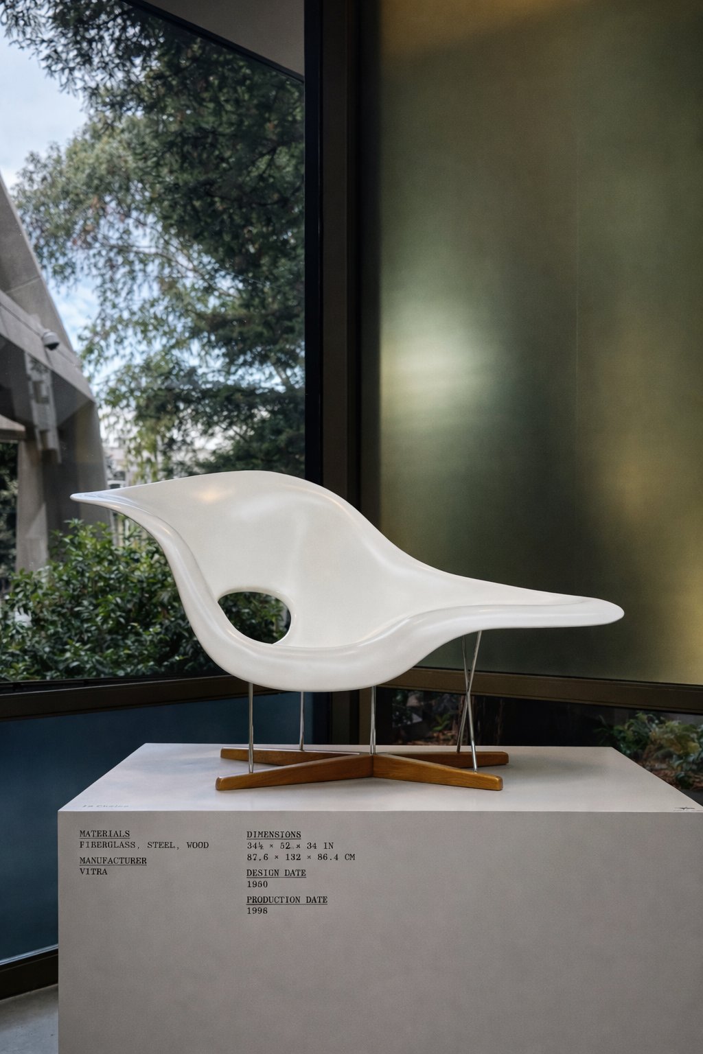 White Eames La Chaise by Vitra displayed in the Transamerica Pyramid with a sign reading 