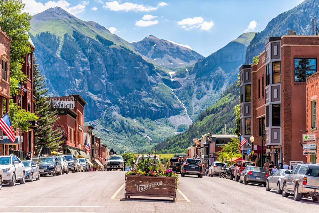 Downtown Telluride, Colorado, with mountain views in the background.