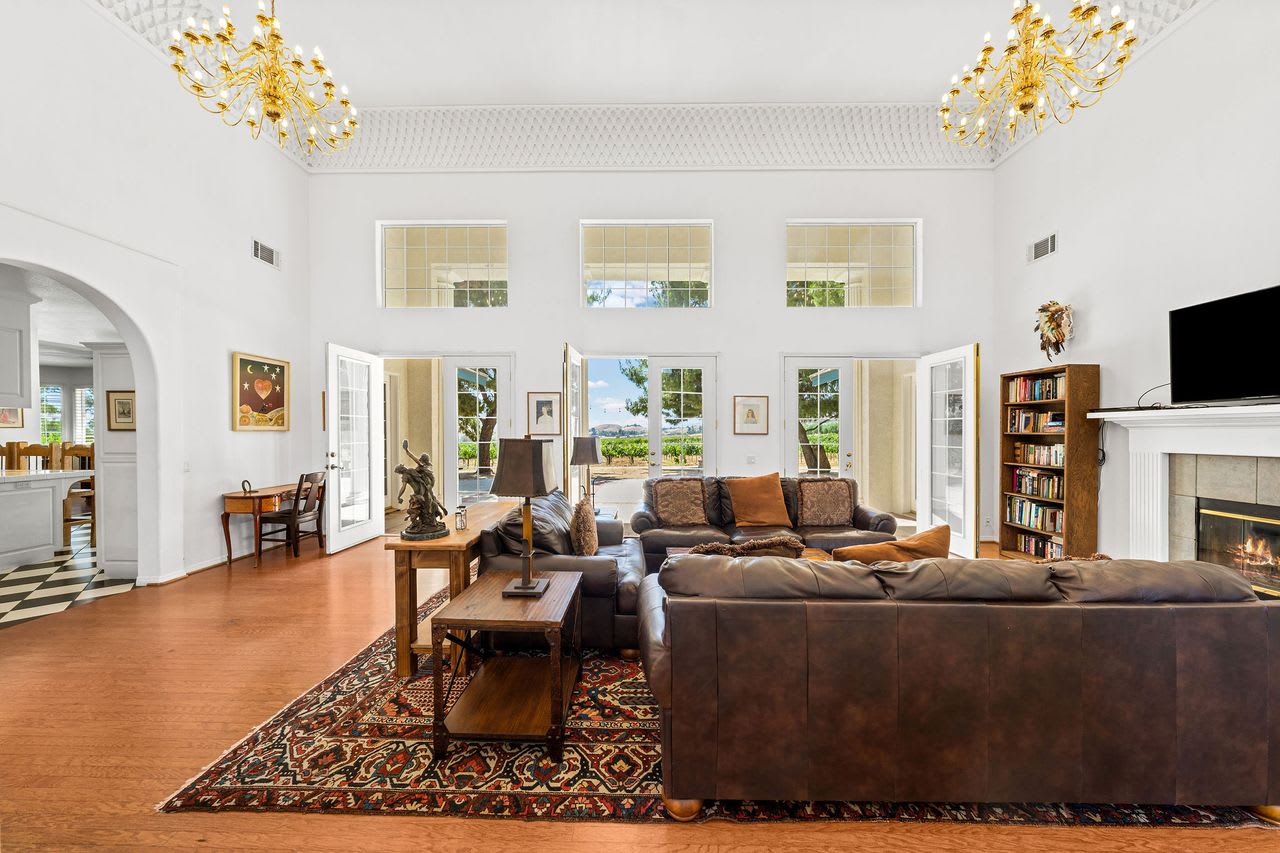 Elegant living room with vineyard views at a Los Angeles winery property for sale.