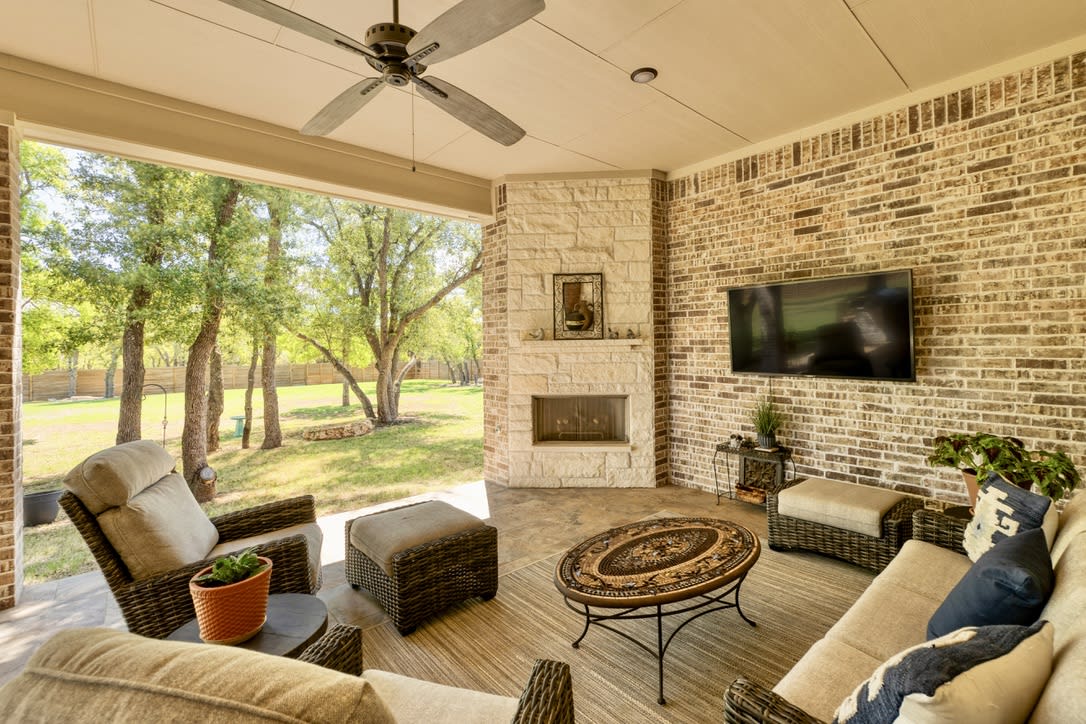 At the heart of the patio stands a magnificent fireplace, beckoning you to gather around and bask in its warm glow. Whether it's a cozy evening with loved ones or a lively outdoor gathering, the fireplace adds an undeniable charm and creates the perfect ambiance for any occasion.