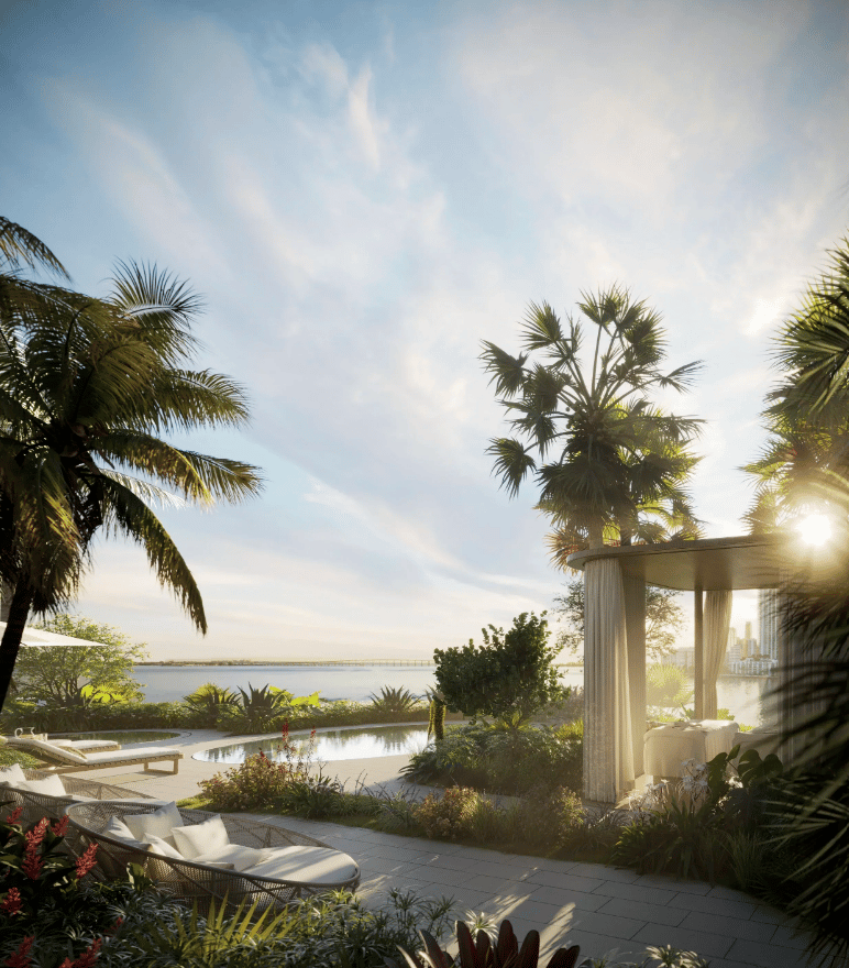 Luxury terrace with a pool, cabana, and loungers overlooking the water at sunset.