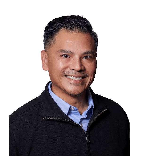 Jason Pugay smiling in a black jacket and light blue shirt.