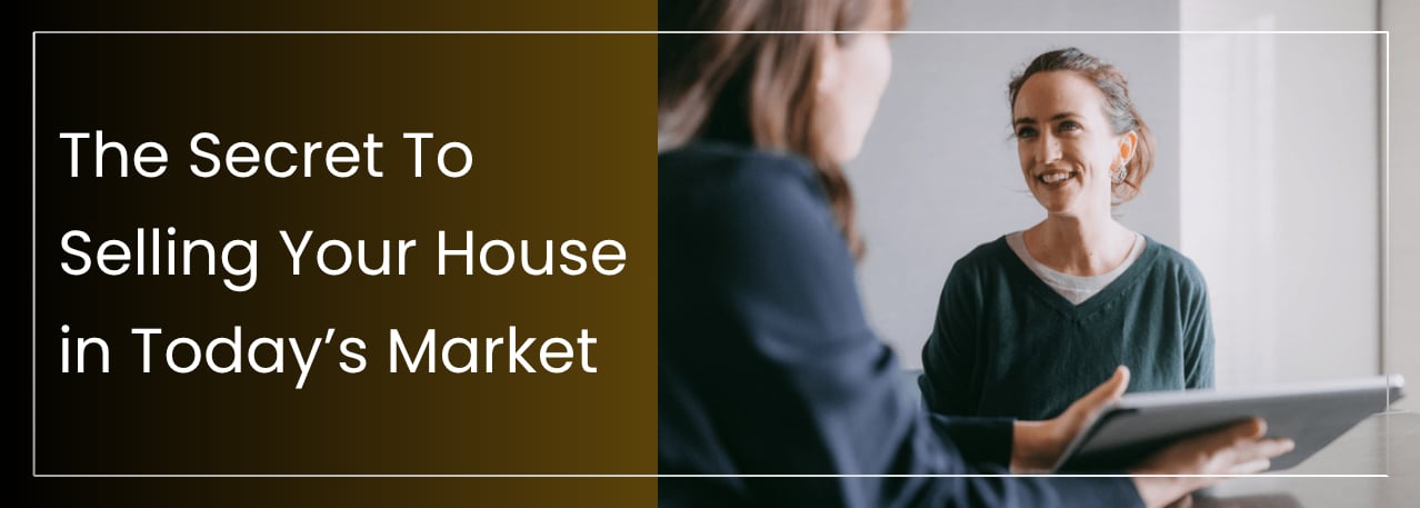 Smiling real estate agent discussing home pricing strategy with a client across the table.