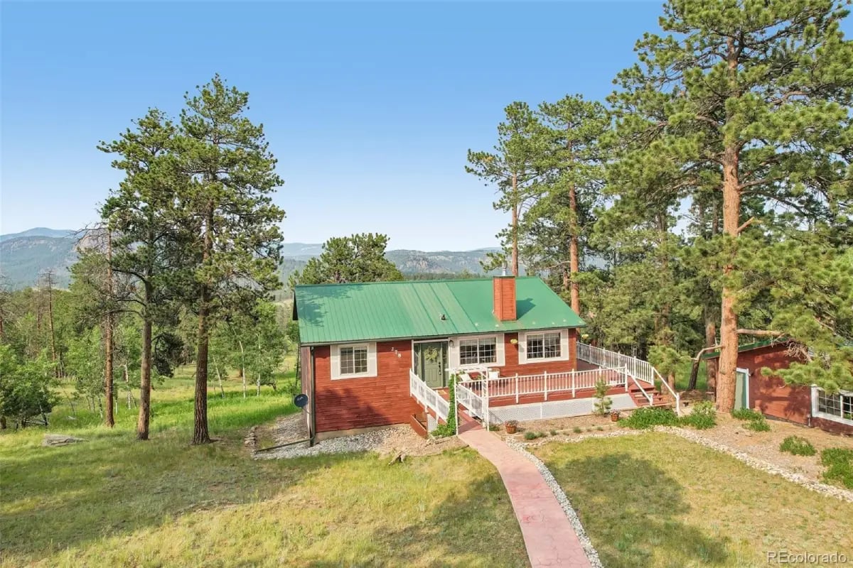 Mountain cabin exterior with a green roof and scenic valley views at 278 Overlook Drive.