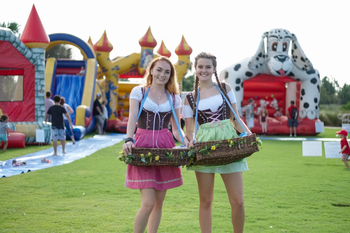 Panama City Beach Oktoberfest attendees in traditional German attire celebrating at the annual festival in Panama City Beach, Florida.