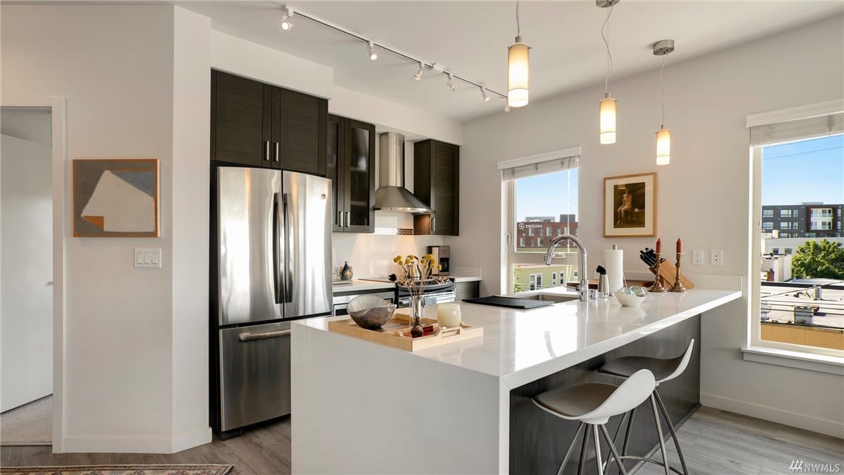 Modern condo kitchen with clean lines and a bright, welcoming atmosphere featuring urban window views.