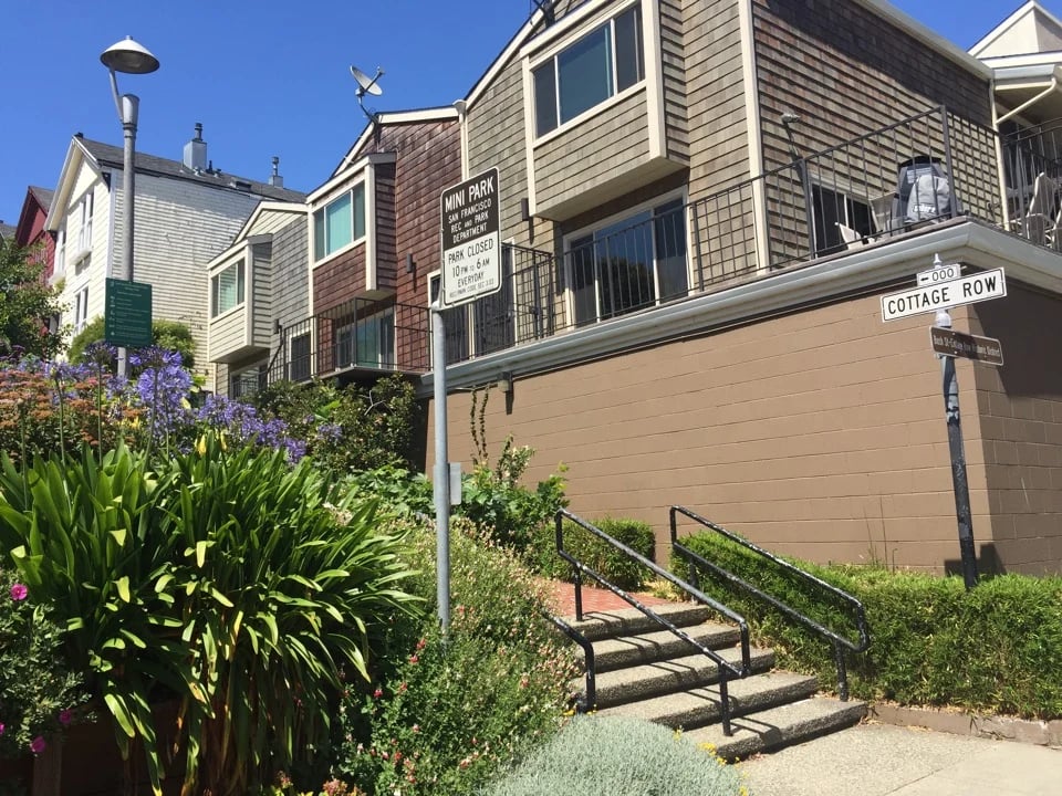 Stairs, plantings and a Cottage Row street sign at the entrance to Cottage Row Mini Park in San Francisco