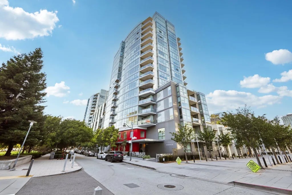 Street view of Madrone San Francisco high-rise apartment building featuring glass facade, concrete construction, and integrated retail space at ground level