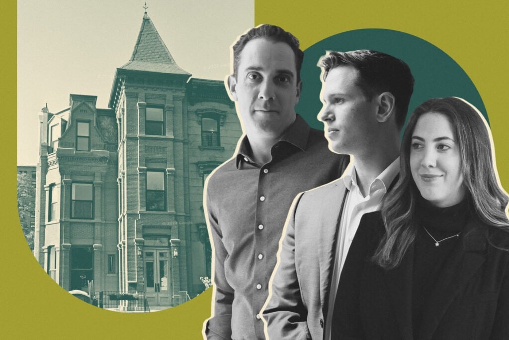 Three real estate agents posed in front of a historic city building.