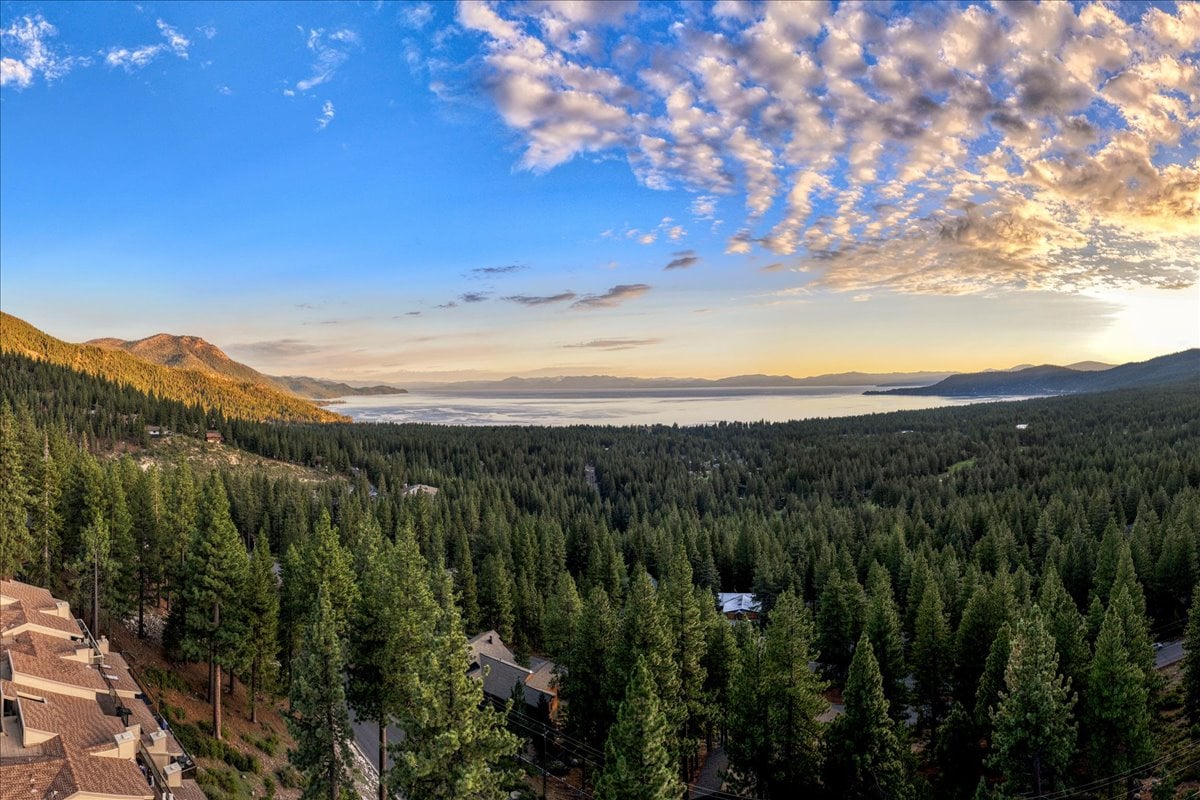 Scenic view of Incline Village homes overlooking Lake Tahoe on a sunny day.