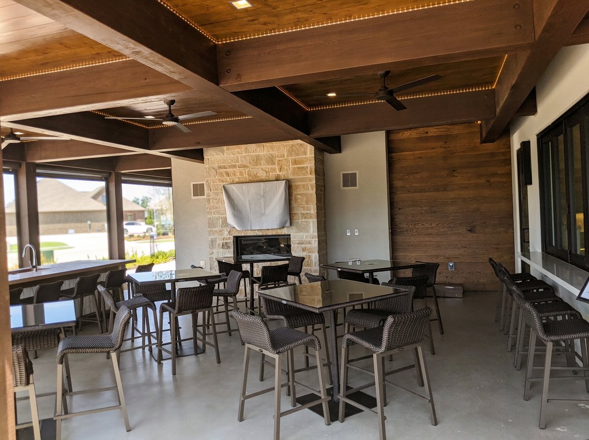 Patio area near grilling station and indoor kitchen with pass thru window  at the  Magnolia Lifestyle Center reserved for the residents of the age restricted Elements at Viridian.