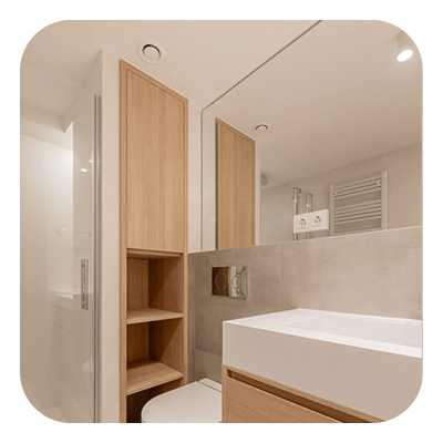 Modern bathroom with a white vanity sink, beige tile, and light wood open shelving.