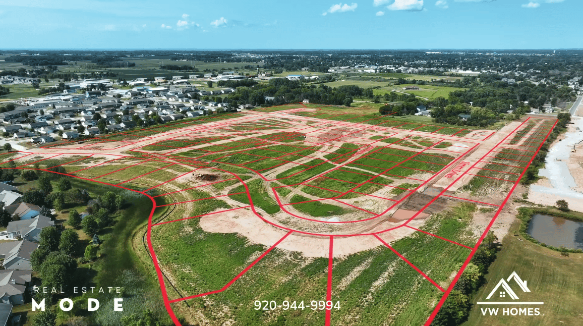 Aerial view of a new subdivision, with red lot boundaries outlining parcels and roads under development.
