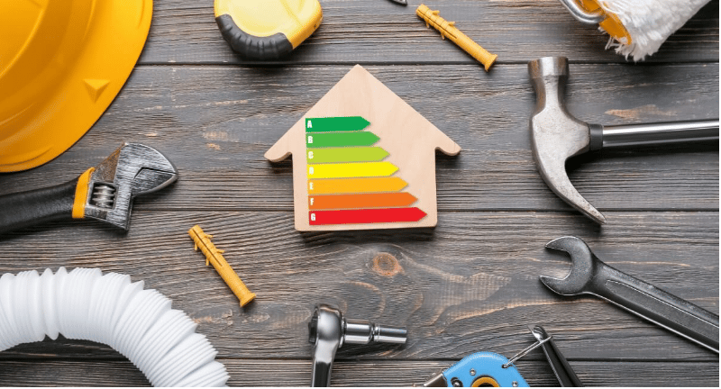 Home energy-efficiency rating surrounded by plumbing and repair tools.
