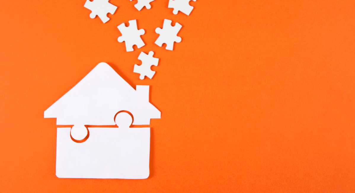 White puzzle pieces form a house, with loose pieces above it on an orange field.