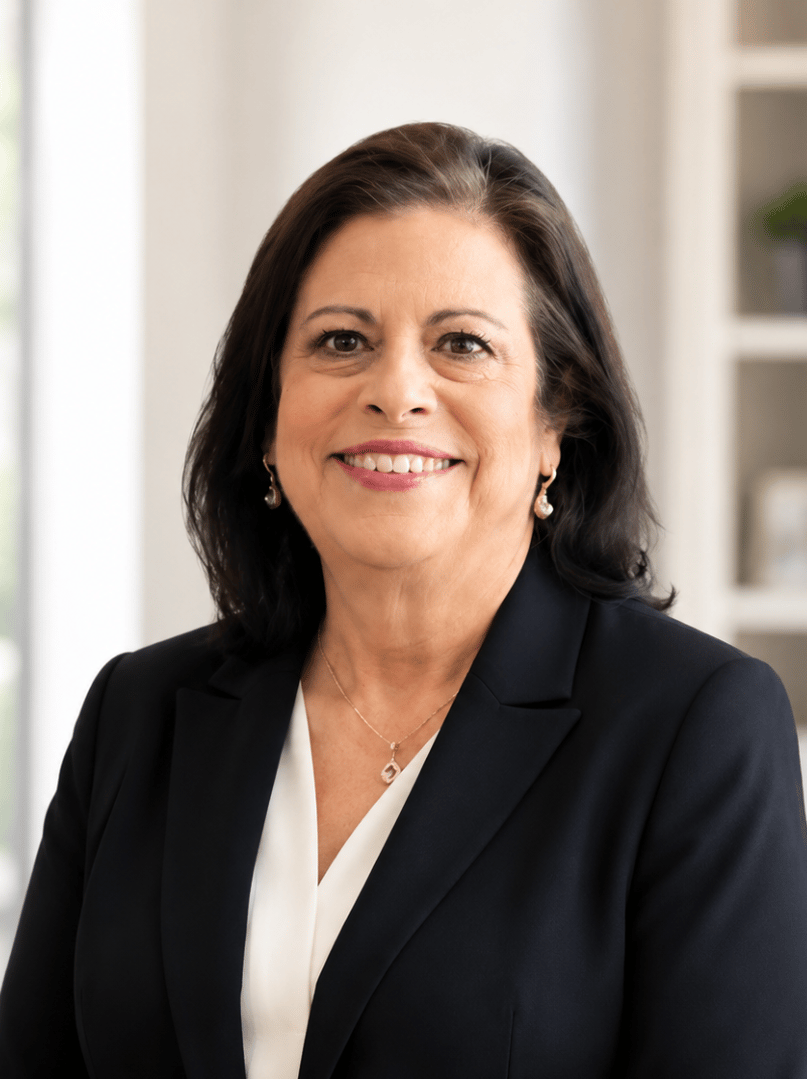 Brenda Galena smiling in a dark blazer and white blouse.