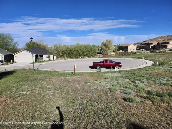 Residential cul-de-sac in Silt with a red pickup and homes on a hillside.