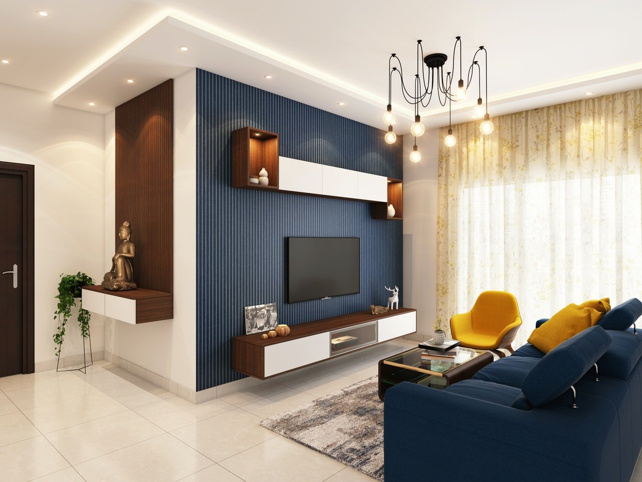 Living room with a blue striped TV wall, navy sectional, and yellow accent chair.