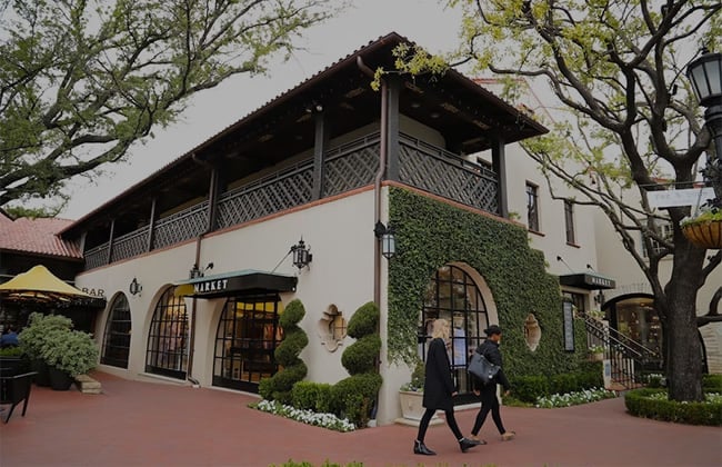 two people walking outside a cafe in Highland Park Dallas