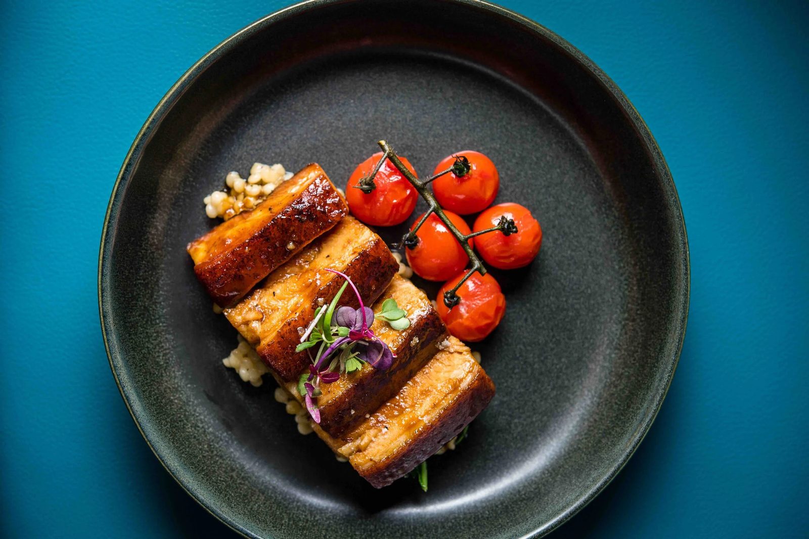 A pork belly dish plated at Fable and Spirit.