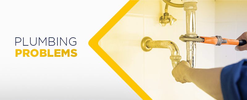 Plumbing problems banner with a plumber tightening a pipe fitting.