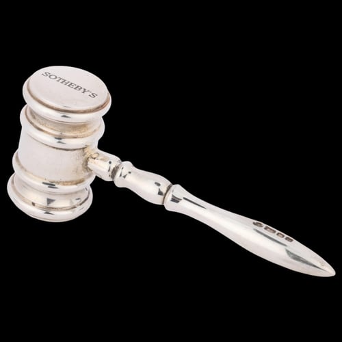 Silver Sotheby's auction gavel on a black background.