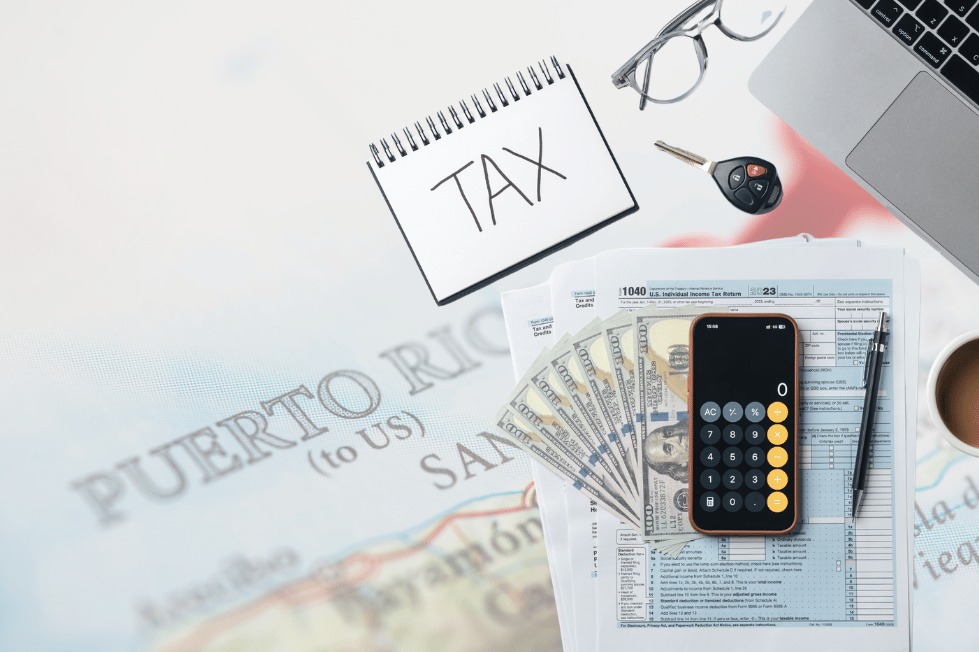 Puerto Rico tax forms with money, calculator, laptop, and coffee.