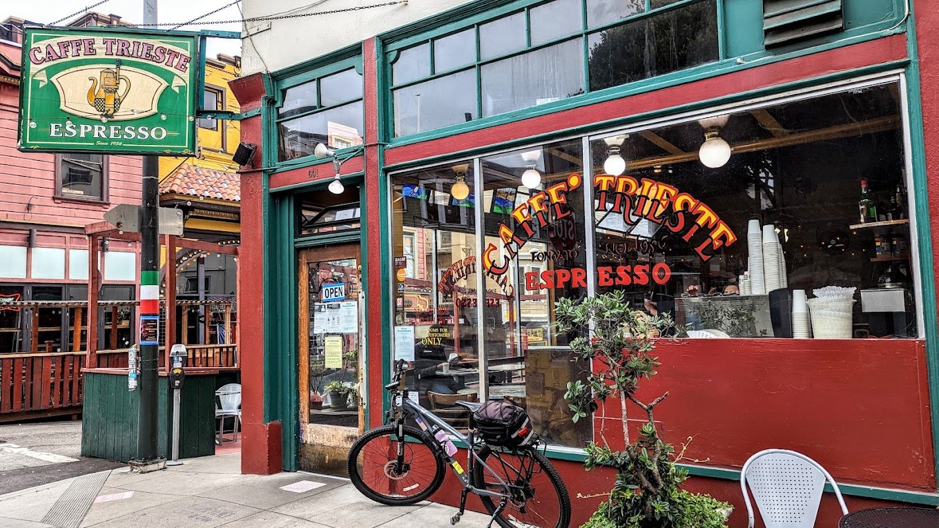 Historic interior of Caffe Trieste in North Beach, with patrons enjoying coffee and its artistic ambiance.