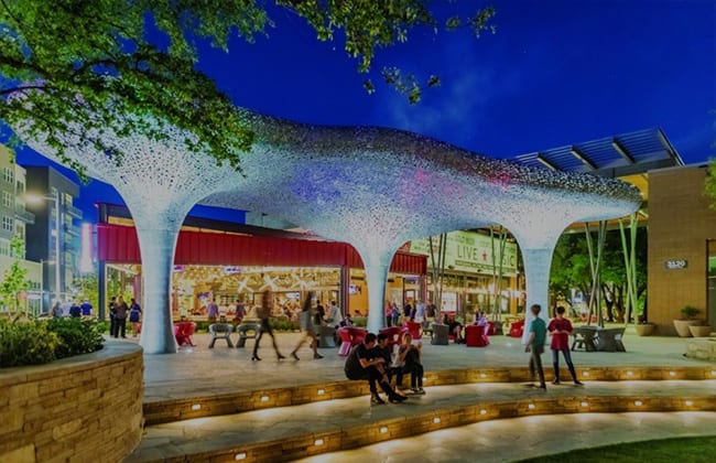 a photo of people strolling outside an establishment in North Austin Texas