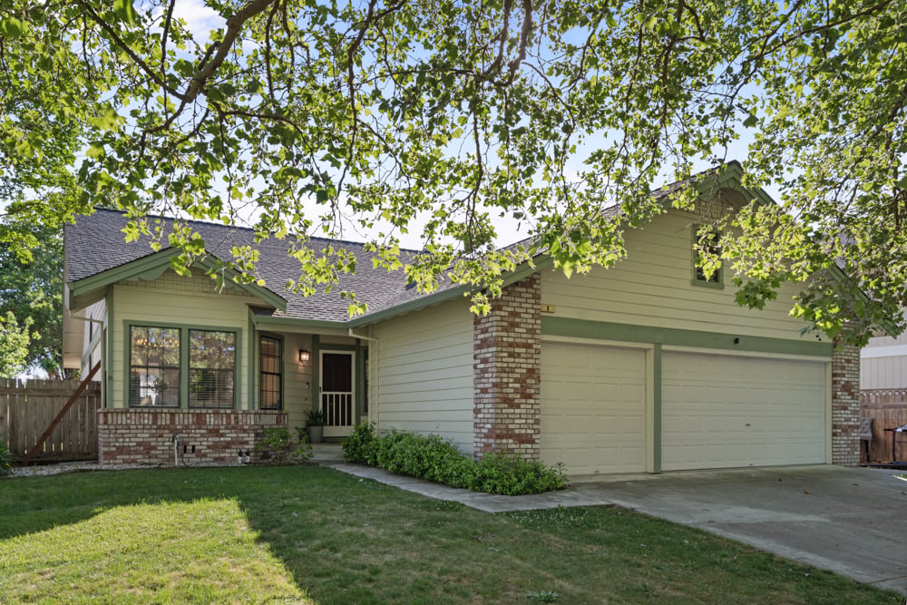 Front exterior of single-level home in Village East Petaluma with landscaped yard