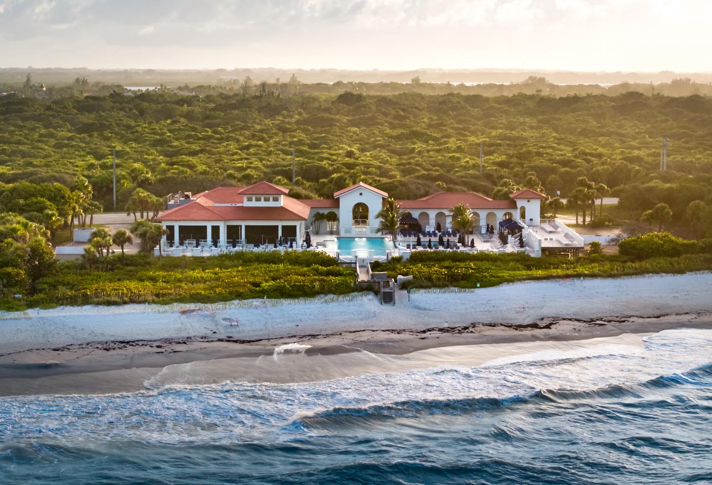 Luxury oceanfront estate in Vero Beach Florida at golden hour, aerial view