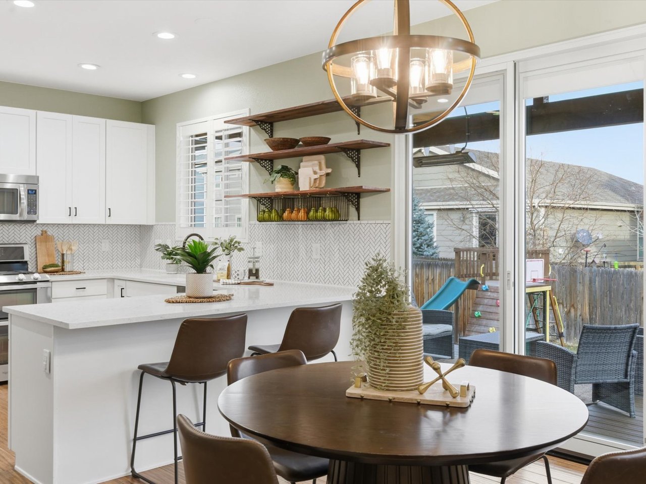 Open-concept kitchen and dining area in an Arvada Colorado home with modern finishes and natural light