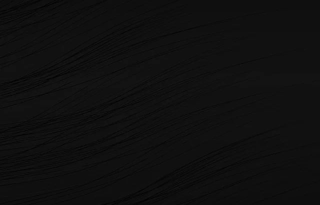 Nearly black wood-grain texture with fine sweeping diagonal lines.