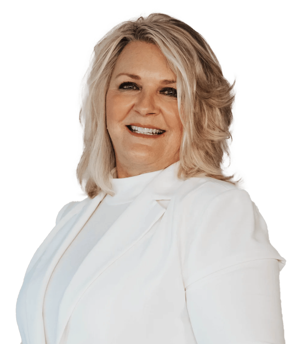 Smiling woman with shoulder-length blonde hair wearing a white blazer.