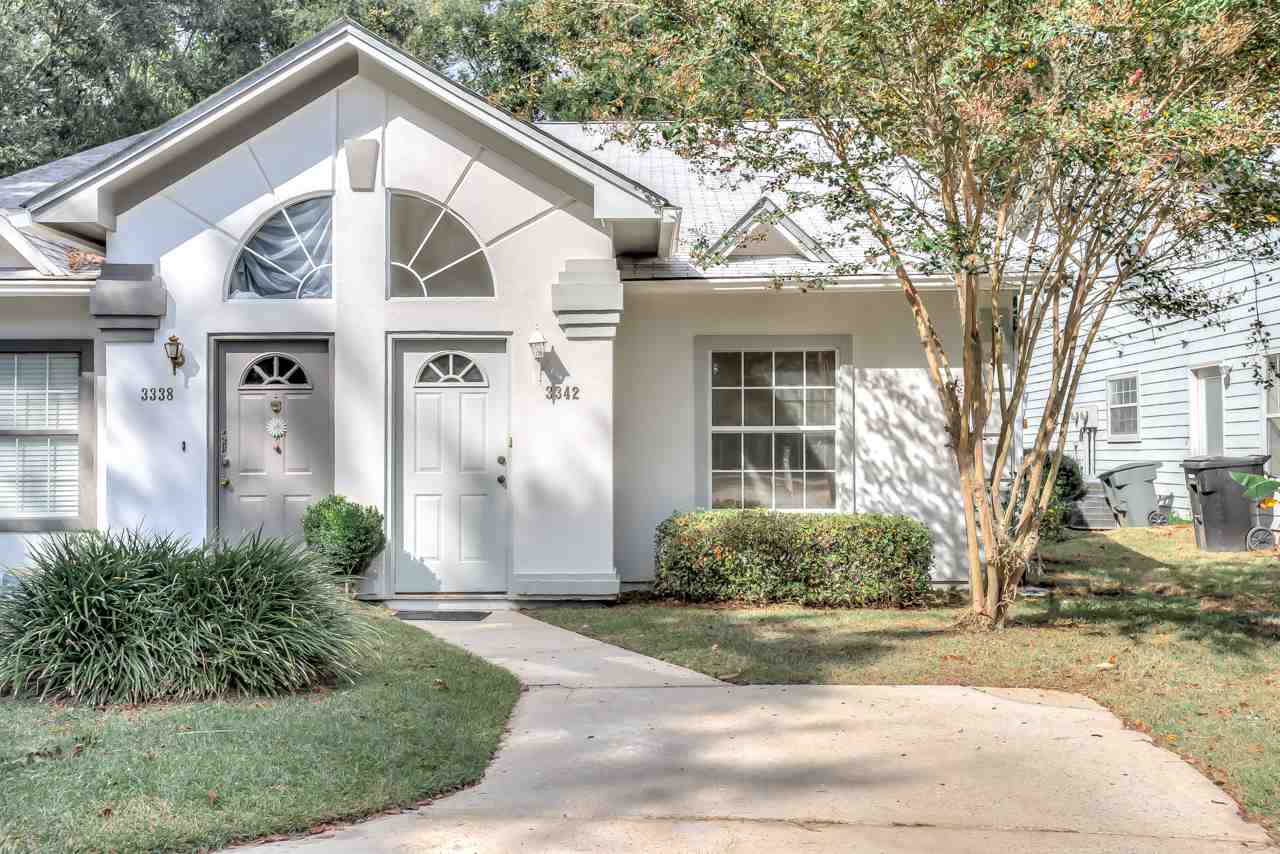 A suburban home in Charlotte, NC, featuring a well-maintained lawn and a welcoming front porch.