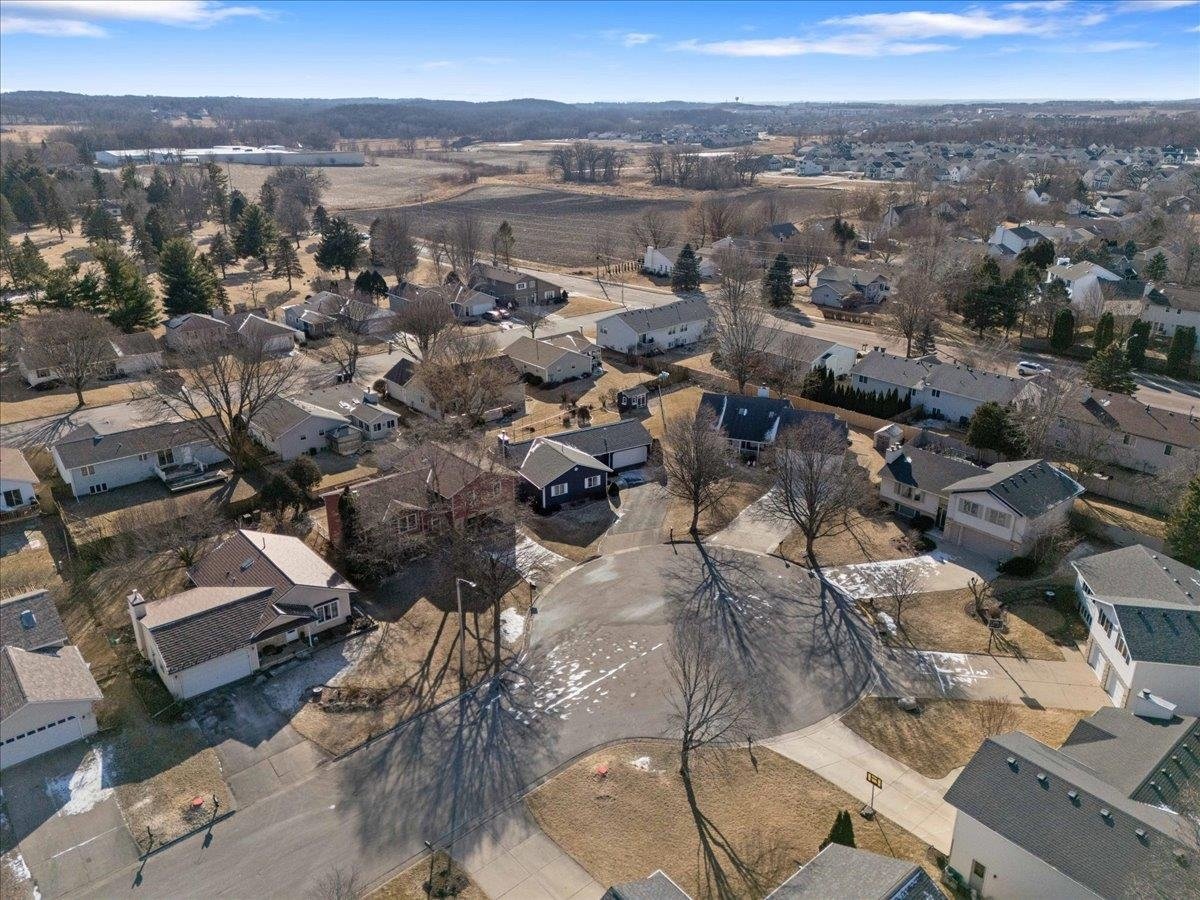 Aerial drone view of a quiet cul-de-sac in an established Sun Prairie neighborhood, featuring single-family starter homes that are highly sought after in today's fast-paced real estate market.