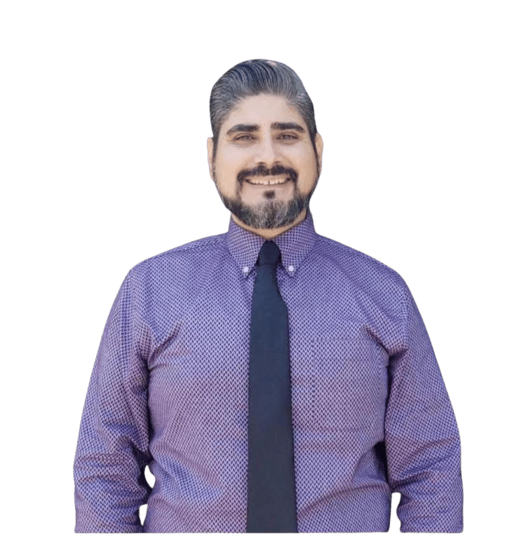 Gil Ordonez smiling in a purple patterned shirt and dark tie.