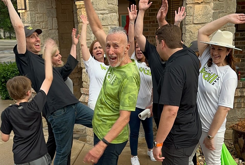 Individuals raising their hands and having fun