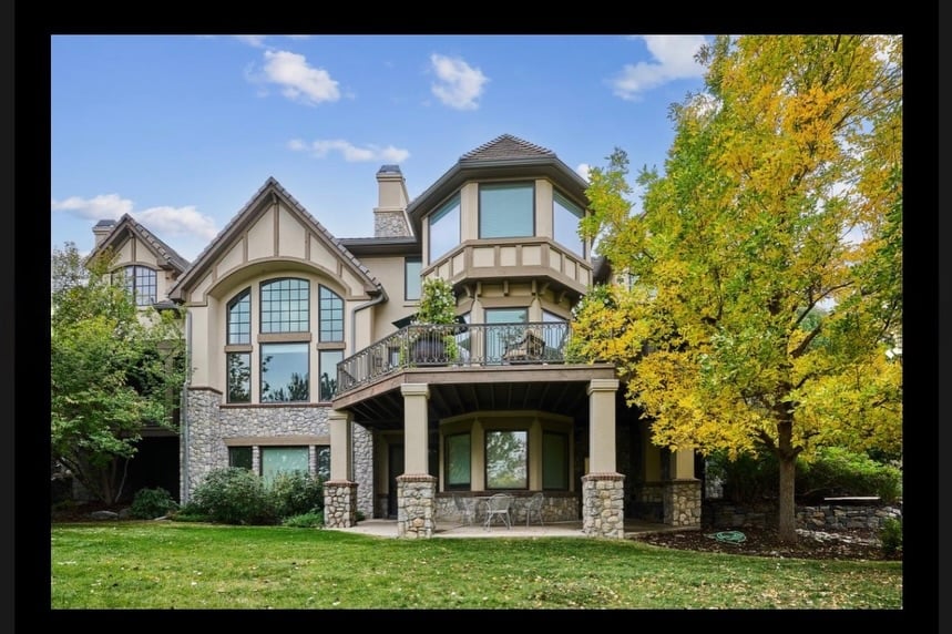 Grand exterior of luxury estate in The Preserve at Greenwood Village, circular drive, manicured landscape, evening lighting.