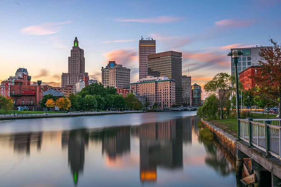 Providence skyline and autumn trees reflected in the river at sunset.
