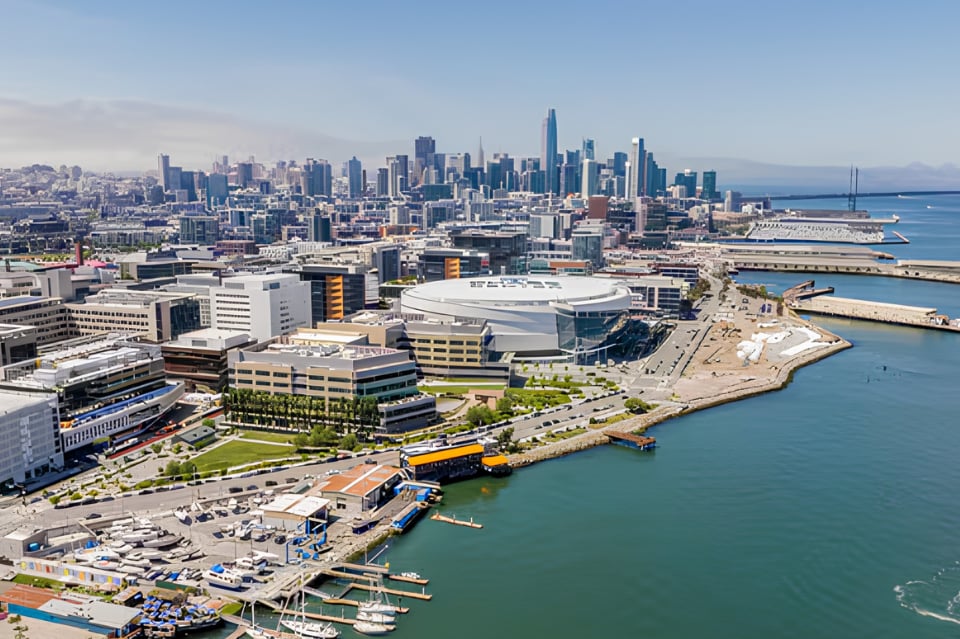 Aerial panorama of San Francisco's downtown skyline and waterfront along the bay.