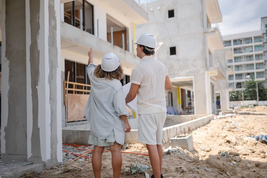 Buyers reviewing new construction home project during property walkthrough in Poconos
