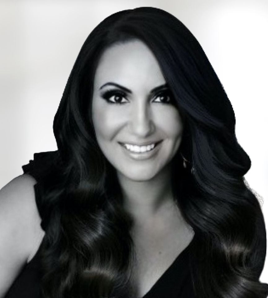 Sylvia Girgis smiling, with long dark hair and a black top.
