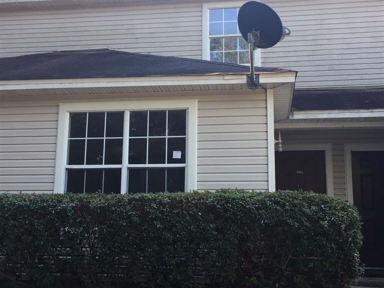 A house featuring a satellite dish prominently installed on its roof.