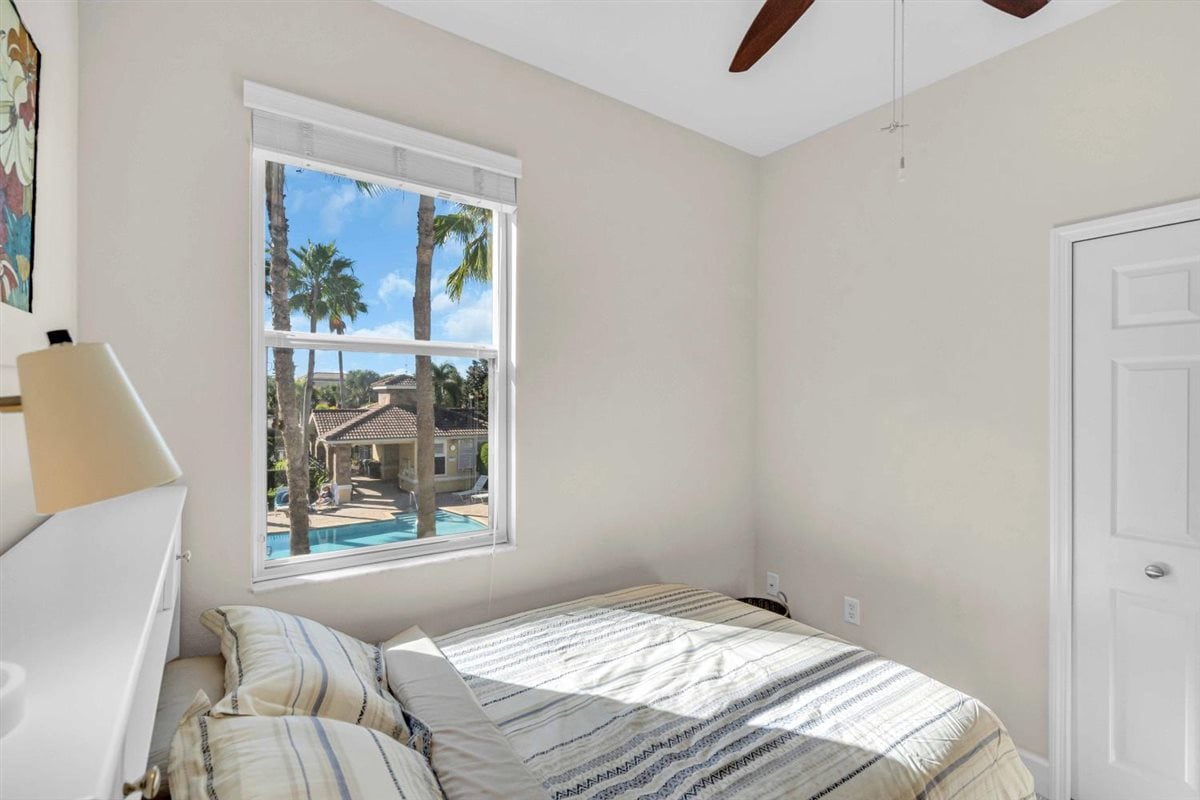 Bedroom two offers a view of the pool offering stunning sunsets