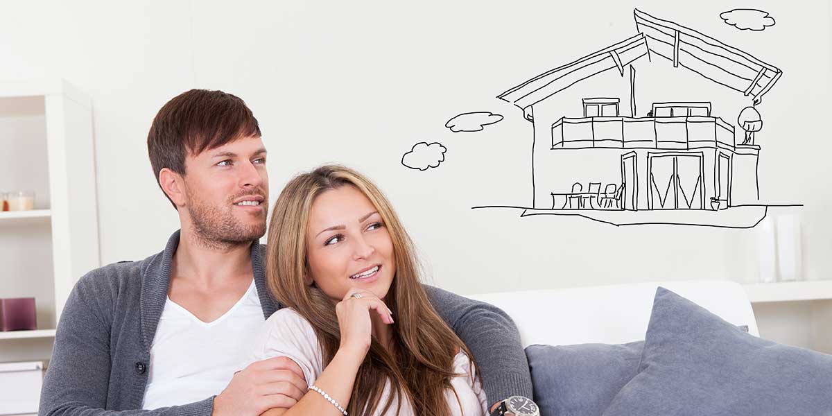 Couple on a sofa imagining a larger two-story home.
