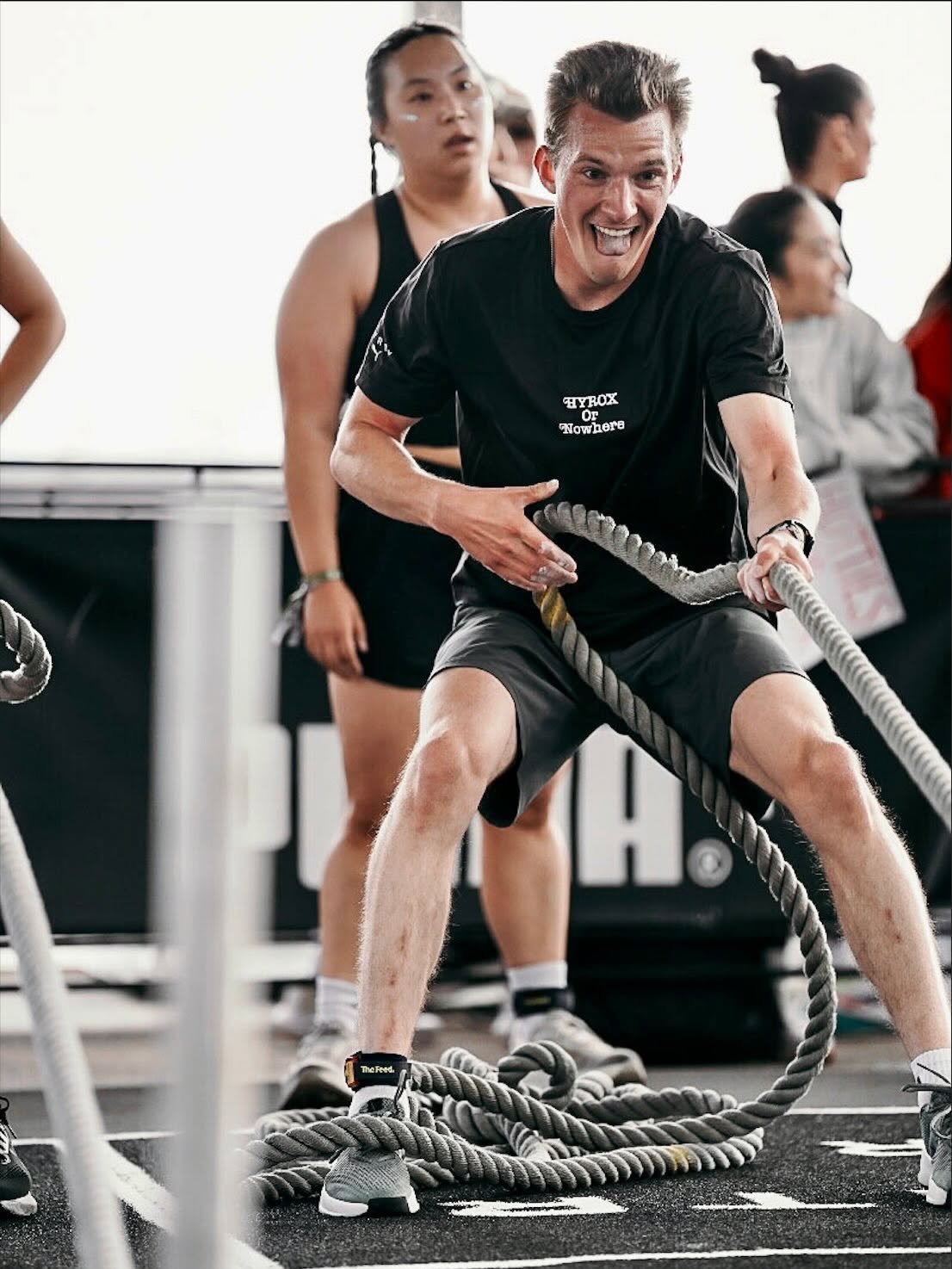 Aaron Mayersky training with battle ropes at a HYROX fitness event