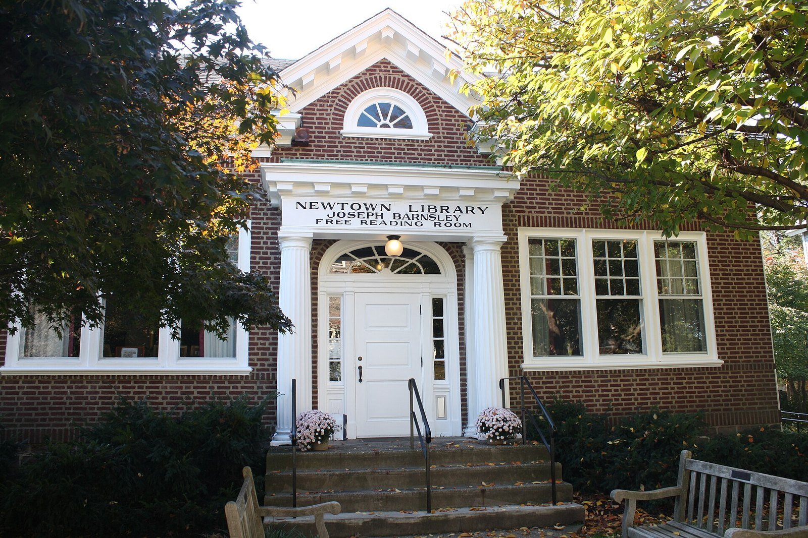 Brick-and-white facade of the Newtown Library Company on a sunny day in Newtown, PA