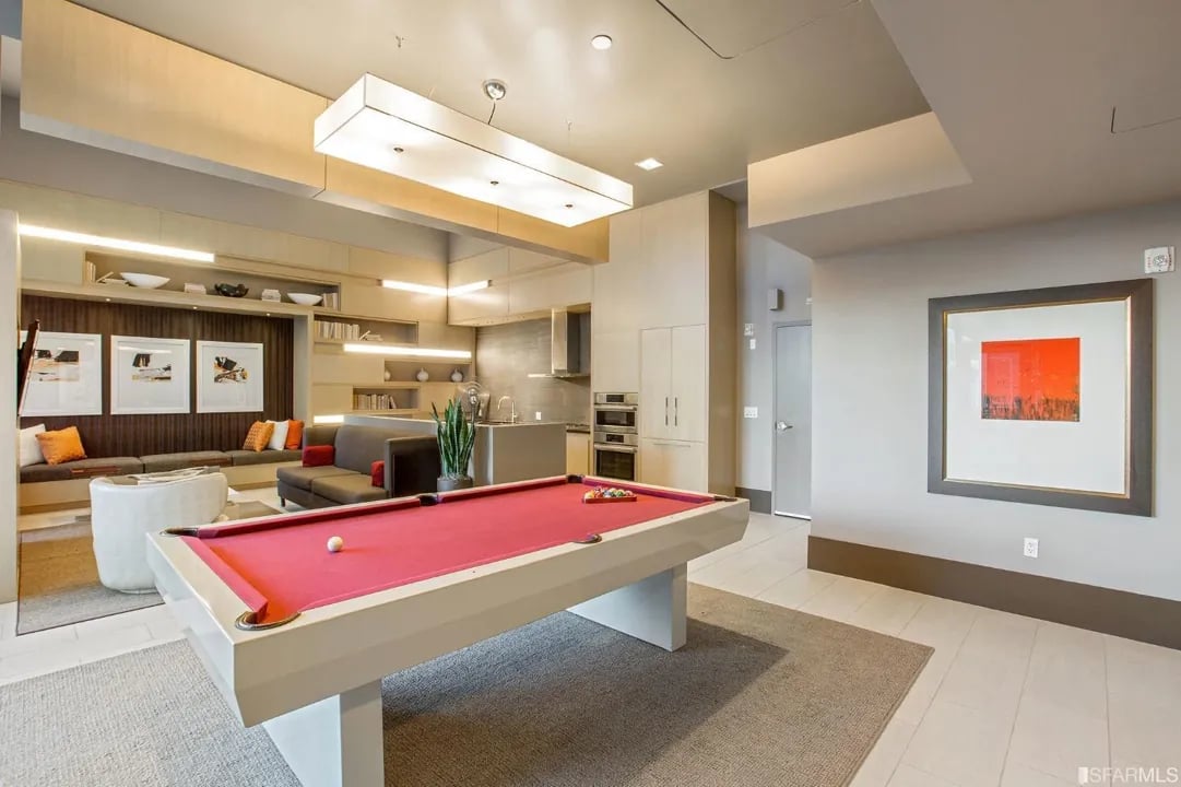 Arden Residences common area with a red pool table and a lounge area.